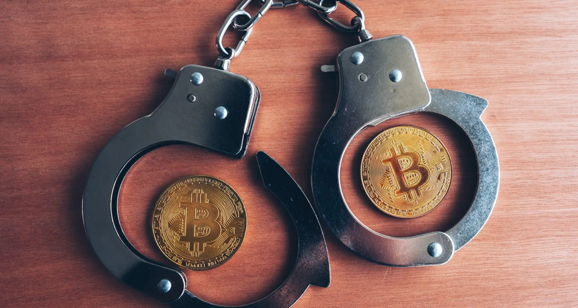 A conceptual image featuring a pair of handcuffs clasping a physical representation of a Bitcoin, suggesting a theme of legal enforcement or a potential SEC investigation into cryptocurrency activities.