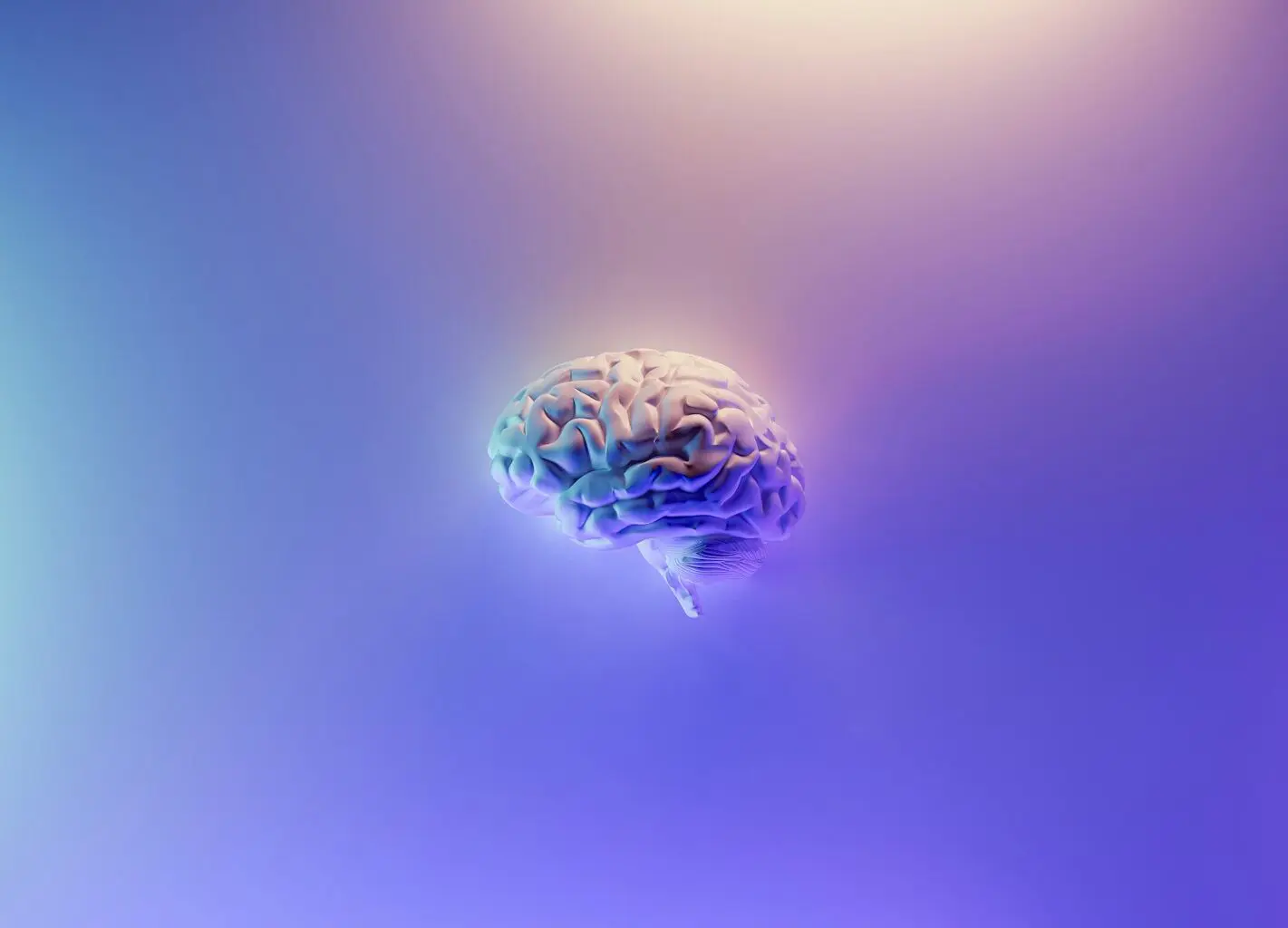A human brain with a glowing effect against a purple and blue gradient background.