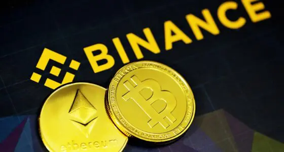 An image of the Binance logo with a physical Bitcoin and Ethereum coin.