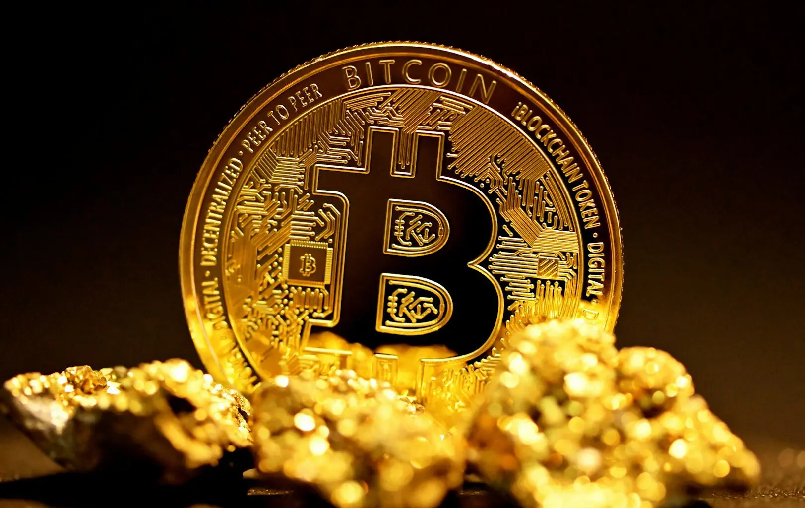 A bitcoin sitting on top of a pile of gold nuggets