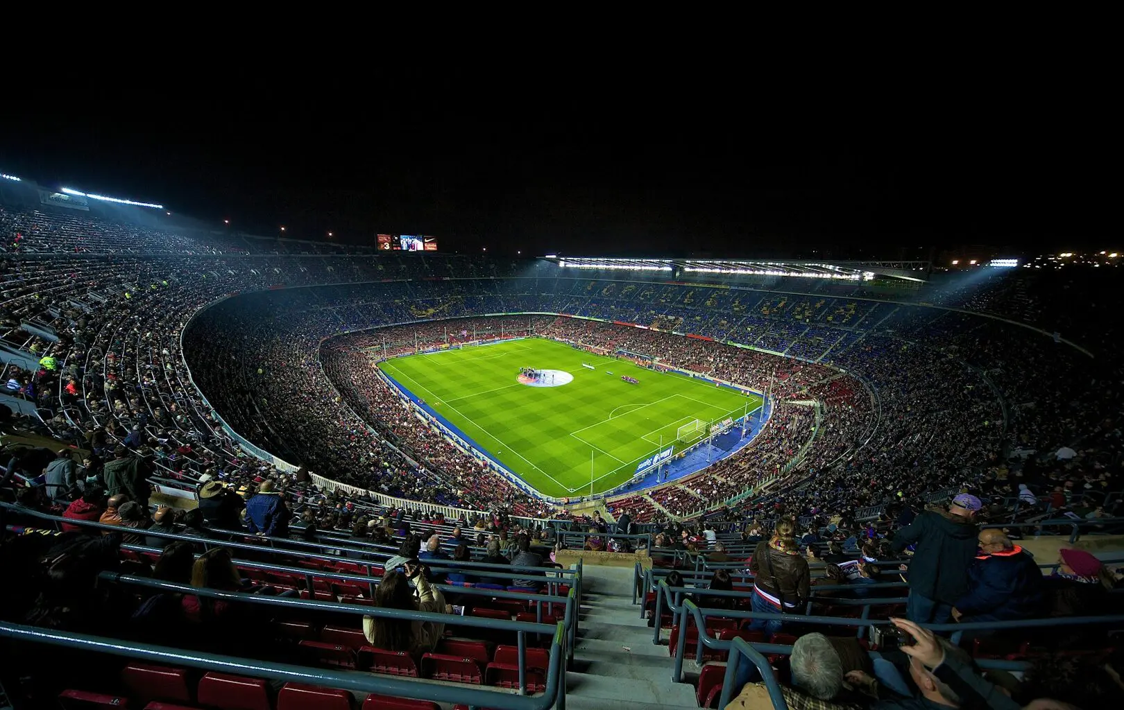 A football stadium filled with people watching a game, FC Barcelona.